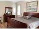 Main bedroom featuring wood furniture, decorative painting, and ample natural light at 1488 Squaw Ln, North Port, FL 34286