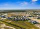 Aerial of a community featuring neighborhood homes, scenic lakes, and lush landscapes under a blue sky at 16029 Mulrion Blvd, Punta Gorda, FL 33982