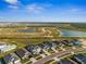 Aerial view showcasing new homes, serene lakes, and expansive green spaces of a community at 16029 Mulrion Blvd, Punta Gorda, FL 33982