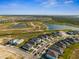 Wide aerial shot of community homes, scenic lakes, and preserved natural landscapes in the distance at 16029 Mulrion Blvd, Punta Gorda, FL 33982