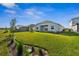 Large backyard with well-maintained lawn, landscaping, and screened pool area at 16029 Mulrion Blvd, Punta Gorda, FL 33982