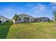 Expansive backyard featuring lush green grass and a screened-in pool enclosure at 16029 Mulrion Blvd, Punta Gorda, FL 33982