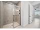 Tiled walk-in shower with glass doors in a naturally lit modern bathroom at 16029 Mulrion Blvd, Punta Gorda, FL 33982