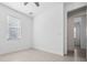 Bright bedroom with ceiling fan, window with blinds, and neutral tile flooring at 16029 Mulrion Blvd, Punta Gorda, FL 33982