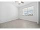 Bright bedroom with ceiling fan, window with blinds, and neutral tile flooring at 16029 Mulrion Blvd, Punta Gorda, FL 33982
