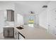 Open-concept kitchen with island seating, stainless steel appliances, and tile flooring at 16029 Mulrion Blvd, Punta Gorda, FL 33982