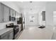 Well-lit kitchen with stainless appliances, light countertops, and sleek cabinetry at 16029 Mulrion Blvd, Punta Gorda, FL 33982