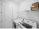Laundry room featuring a modern LG washer and dryer, complemented by a wire shelf above at 16029 Mulrion Blvd, Punta Gorda, FL 33982