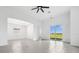 Bright open-concept living area featuring tile floors and sliding glass doors leading to outdoor space at 16029 Mulrion Blvd, Punta Gorda, FL 33982