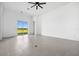 Bright living space features tile flooring, a ceiling fan, and sliding doors to the outside at 16029 Mulrion Blvd, Punta Gorda, FL 33982