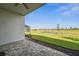 Paver patio showcasing a tranquil backyard view with a pond and well-maintained lawn at 16029 Mulrion Blvd, Punta Gorda, FL 33982