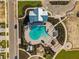 Aerial view of resort-style pool with spacious deck, lush landscaping, and elegant pool house at 16029 Mulrion Blvd, Punta Gorda, FL 33982