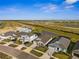 Exterior street-view featuring modern homes, well-kept lawns, and appealing community design at 16029 Mulrion Blvd, Punta Gorda, FL 33982