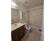 This clean bathroom features a vanity, mirror, tub-shower combination and tile flooring at 19583 Kapok Ct, Port Charlotte, FL 33952