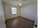 This bright bedroom has wood-look floors and a large window for natural light at 19583 Kapok Ct, Port Charlotte, FL 33952