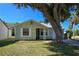 Lovely one-story home with mature trees and a lush green lawn at 19583 Kapok Ct, Port Charlotte, FL 33952