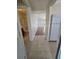 Hallway with tile and wood flooring leading to different rooms, including a bathroom at 19583 Kapok Ct, Port Charlotte, FL 33952