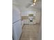 Well-lit kitchen with white cabinetry, electric range, and tile flooring at 19583 Kapok Ct, Port Charlotte, FL 33952