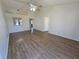 Large living room with wood floors, a ceiling fan, and an open layout to the kitchen at 19583 Kapok Ct, Port Charlotte, FL 33952