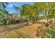 Expansive backyard with mature trees and a wooden fence, perfect for outdoor activities at 2002 Central Ave, Sarasota, FL 34234