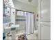 Stylish bathroom featuring patterned tiles, a pedestal sink, and a tiled shower with a curtain at 2002 Central Ave, Sarasota, FL 34234