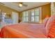 Charming bedroom featuring light-colored carpet, three windows, and a ceiling fan at 2002 Central Ave, Sarasota, FL 34234