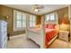 Comfortable bedroom with three windows, a ceiling fan, and light-colored carpet at 2002 Central Ave, Sarasota, FL 34234