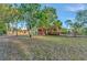 A lush green lawn surrounds a charming coral home with tile roof accents at 2002 Central Ave, Sarasota, FL 34234