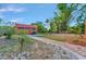 Beautiful single-story home with lush landscaping and a brick pathway leading to the entrance at 2002 Central Ave, Sarasota, FL 34234