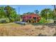 Exterior view of a well-maintained home, enhanced by a lush yard and charming brick walkway at 2002 Central Ave, Sarasota, FL 34234