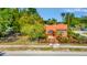 Eye-level view of quaint orange stucco home with secure fenced-in yard and manicured landscaping at 2002 Central Ave, Sarasota, FL 34234