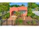 Charming coral stucco home featuring an arched entryway, red tile roof and well-manicured landscaping at 2002 Central Ave, Sarasota, FL 34234