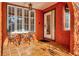 Inviting covered porch with tiled floor, a seating area, and arched entry to this charming home at 2002 Central Ave, Sarasota, FL 34234