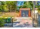 Rear view of newly painted garage with ample storage space and a charming brick driveway at 2002 Central Ave, Sarasota, FL 34234