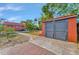 Garage with a brick-lined sidewalk and a vibrant exterior color offering ample storage and curb appeal at 2002 Central Ave, Sarasota, FL 34234