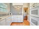 Well-lit kitchen with a tile floor, white cabinets, and access to additional rooms at 2002 Central Ave, Sarasota, FL 34234