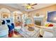 Open-concept living room with hardwood floors, a fireplace, and seamless flow into the dining area at 2002 Central Ave, Sarasota, FL 34234