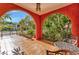 Charming covered patio with tiled flooring, decorative arches, and comfortable seating area at 2002 Central Ave, Sarasota, FL 34234