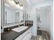 Bathroom featuring a sink with a decorative mirror and wood-look flooring at 22435 Fortune Ave, Port Charlotte, FL 33954