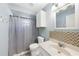 Well-lit bathroom with tile accents, a vanity and a shower at 22435 Fortune Ave, Port Charlotte, FL 33954
