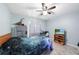 Cozy bedroom with a ceiling fan and natural lighting at 22435 Fortune Ave, Port Charlotte, FL 33954
