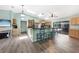 Charming kitchen with a large island and breakfast bar, light wood cabinetry, and stainless steel appliances at 22435 Fortune Ave, Port Charlotte, FL 33954
