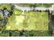 An aerial view of property lines showcasing land features, property dimensions, and nearby trees at 22435 Fortune Ave, Port Charlotte, FL 33954