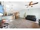 Bright living room with wood floors, high ceilings, comfortable seating, and seamlessly connects to kitchen at 22435 Fortune Ave, Port Charlotte, FL 33954