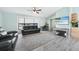 Modern living room featuring neutral-toned walls, wood floors, contemporary furniture, and lots of natural light at 22435 Fortune Ave, Port Charlotte, FL 33954