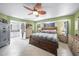 Inviting primary bedroom with tile floor, a large bed, natural light, and a ensuite bathroom at 22435 Fortune Ave, Port Charlotte, FL 33954
