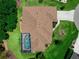 A high aerial view shows a single-Gathering home and it's lush green landscape and screened-in pool at 2288 Prague Ln, Punta Gorda, FL 33983