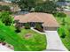 An aerial view of a single-Gathering home with a well-manicured lawn and beautiful landscaping at 2288 Prague Ln, Punta Gorda, FL 33983