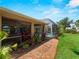 Beautiful backyard featuring a screened-in pool, tropical landscaping, and a spacious grassy area at 2288 Prague Ln, Punta Gorda, FL 33983