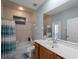 Tiled bathroom featuring a tub/shower combo, a wood vanity, and neutral tones at 2288 Prague Ln, Punta Gorda, FL 33983